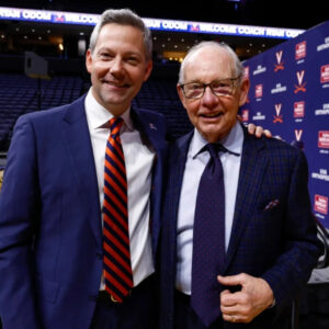 Ryan Odom stands with his father Dave at Virginia’s John Paul Jones Arena.