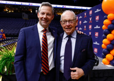 Ryan Odom stands with his father Dave at Virginia’s John Paul Jones Arena.